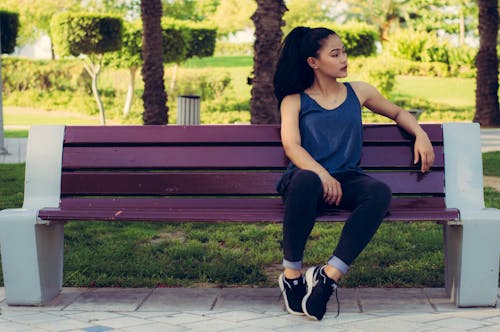 Free Woman Sitting on Purple Bench Stock Photo