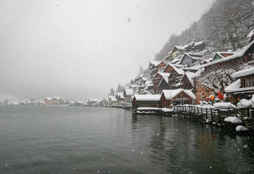 Village on mount against lake in wintertime