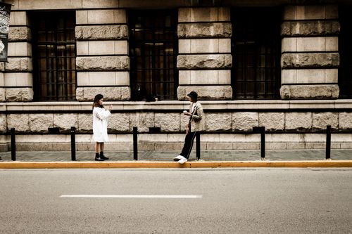 Free Two adults captured in a modern street fashion scene in Shanghai, China. Stock Photo
