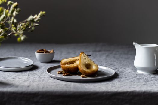 Delicious baked pears served on a stylish plate, perfect for a dessert setting.