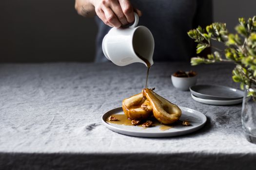 A close-up of poached pears drizzled with maple syrup, perfect for dessert lovers.