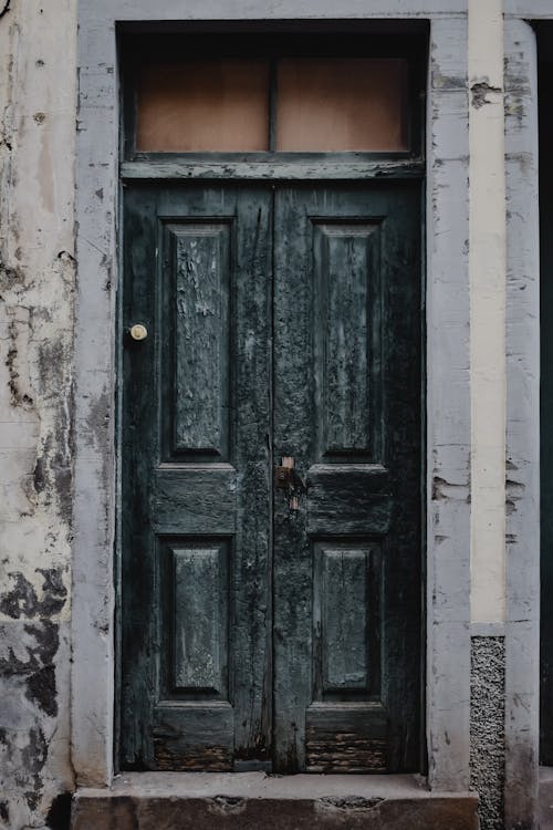 Black Wooden Door on Gray Concrete Wall