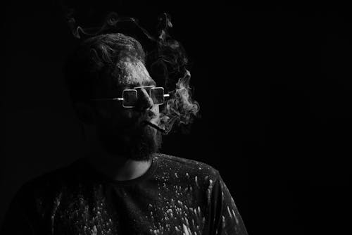 Black-and-White Photo of a Bearded Man with Sunglasses Smoking Cigarette