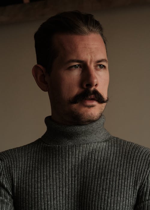 Close-Up Shot of a Man in Gray Turtleneck Sleeves
