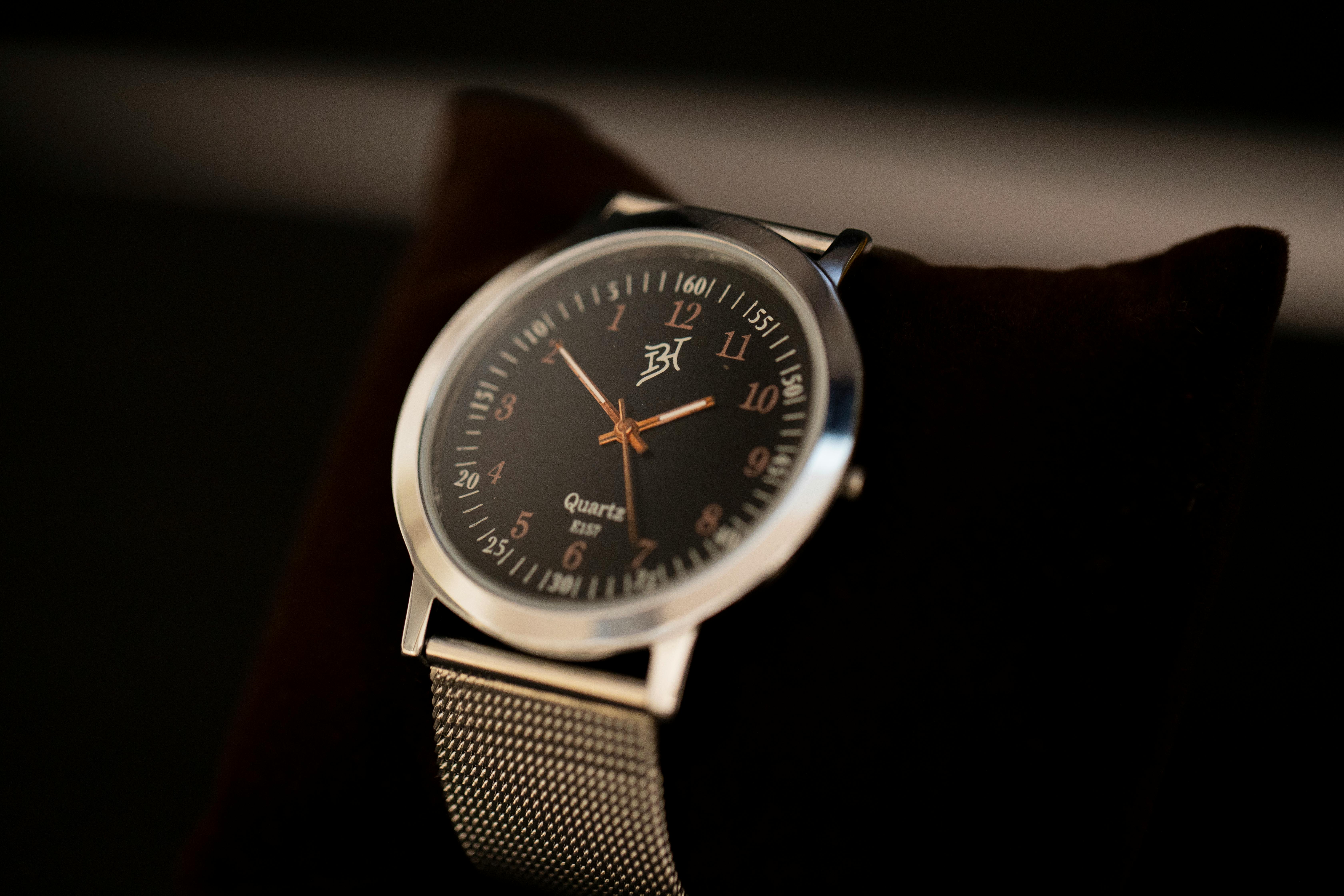 Close-up of an elegant silver wristwatch with a classic design, focusing on its face and metal band.