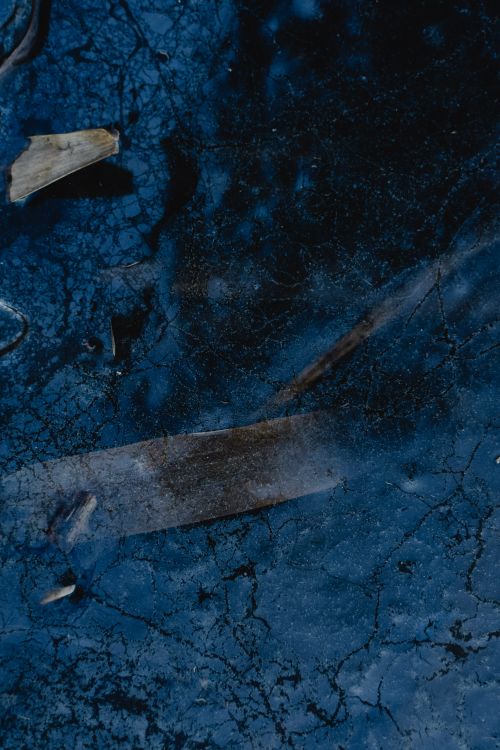 Free A detailed view of cracked ice with natural textures on a winter day in Estonia. Stock Photo