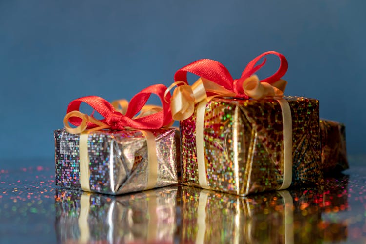 Gold And Silver Gift Boxes With Red Ribbon