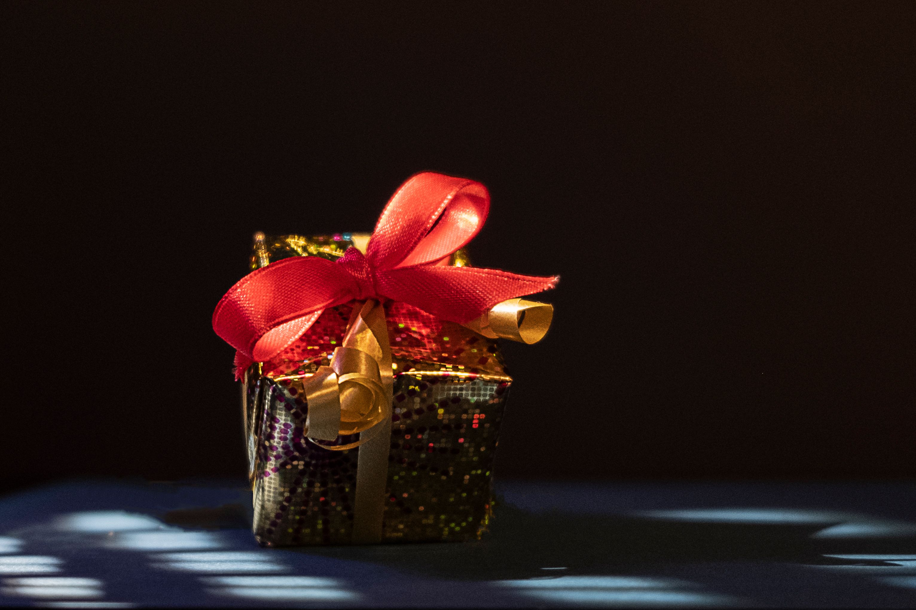 Close-up of an ornate gift box with red ribbon, perfect for special occasions.