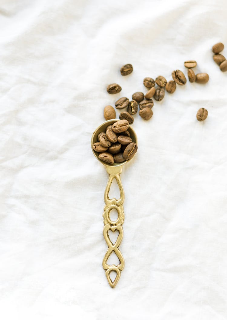 Coffee Beans On Gold Spoon 