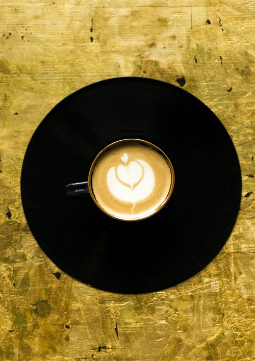 Free Captivating top-down view of a cappuccino with heart-shaped latte art on a rustic background, perfect for coffee lovers. Stock Photo