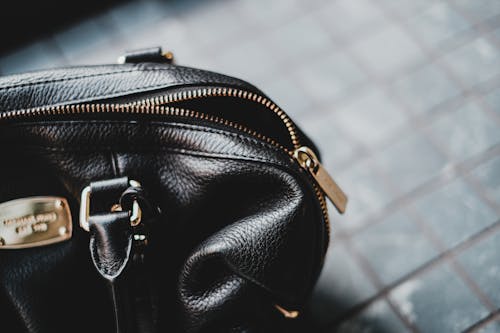 Black Leather Handbag on White and Black Textile