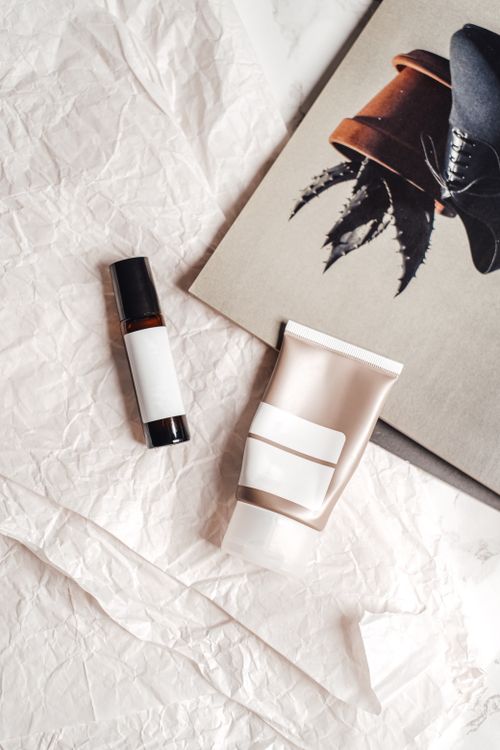 Free Flat lay of skincare products on crumpled paper with artistic background. Stock Photo