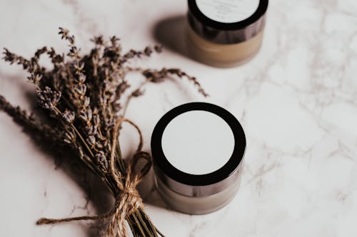 White and Black Cosmetic Product Container on the Table