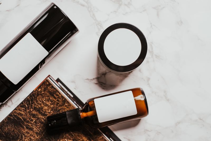 Minimal skincare products arranged in a flat lay on a pale marble surface