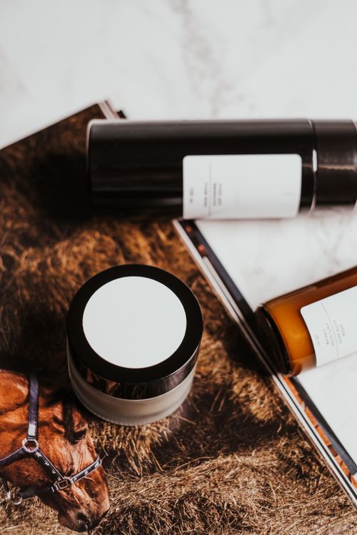 Free Minimalist display of cosmetic products on a marble background with earthy aesthetics. Stock Photo