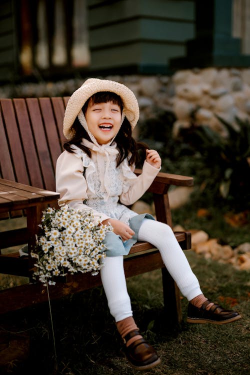 Happy Asian girl sitting on chair