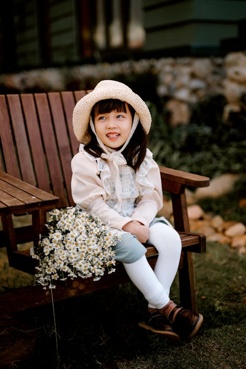 Cheerful Asian girl on wooden chair