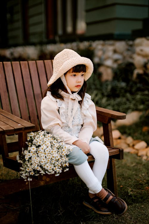 Calm Asian girl sitting on backyard