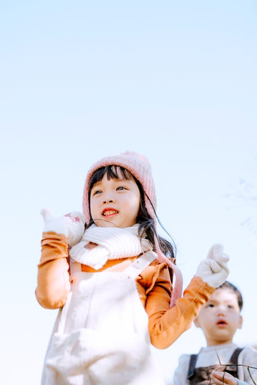 Cheerful Asian siblings in nature