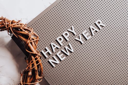 Free Happy New Year Text Message Next to Brown Wreath Stock Photo