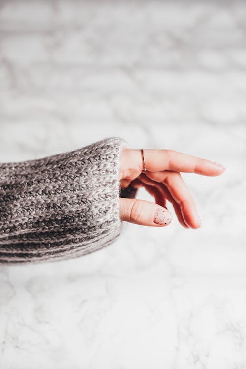 Free Person in Gray Knit Sweater Wearing a Silver Ring  Stock Photo