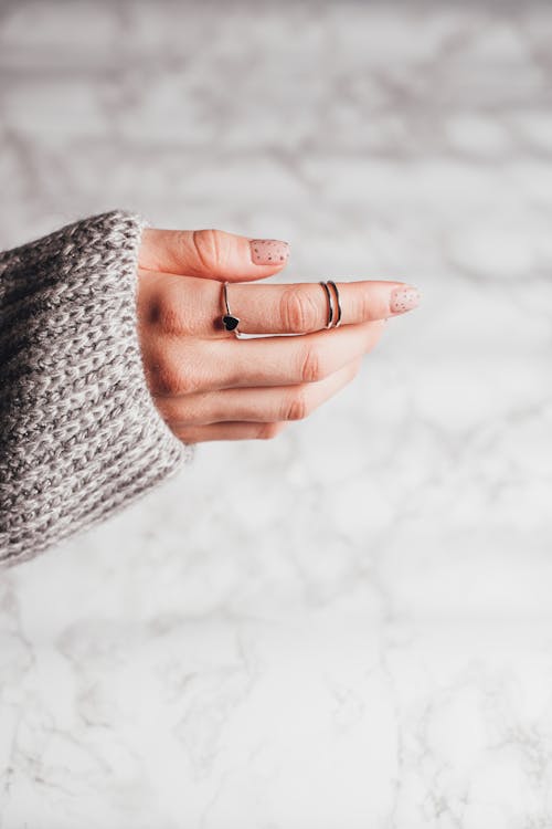 Free Person with Manicured Nails Wearing Silver Rings  Stock Photo