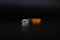 Orange and Silver Lighter in Black Background