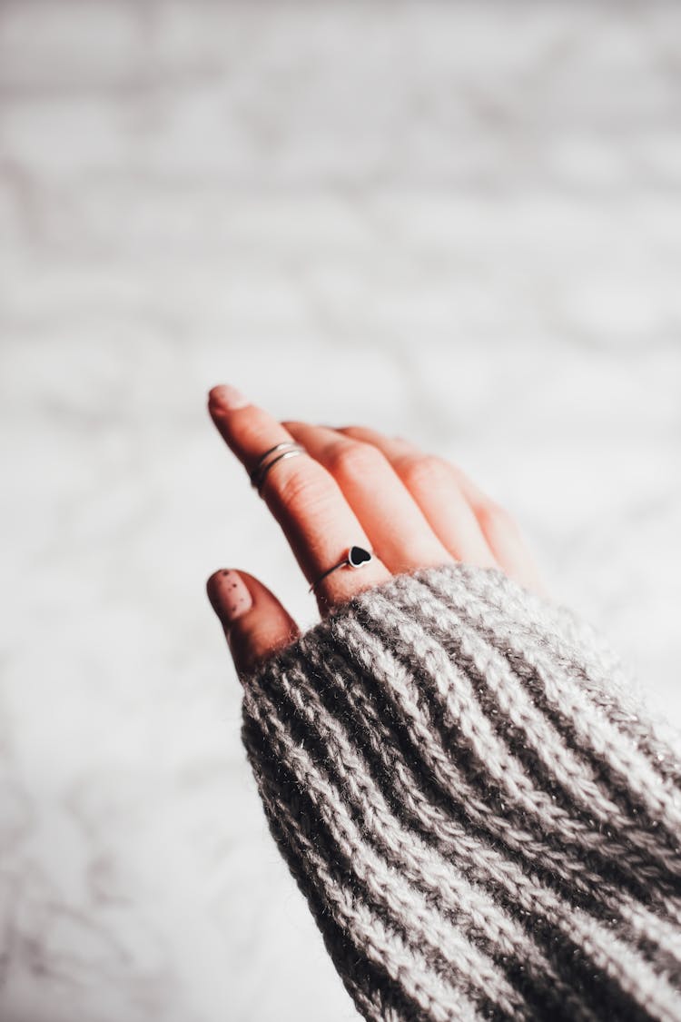 Silver Rings On The Person's Index Finger 