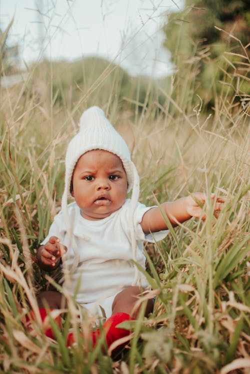 Cute Baby sitting on Grass 