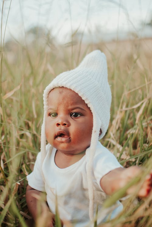 Free Cute Baby sitting on Grass Stock Photo