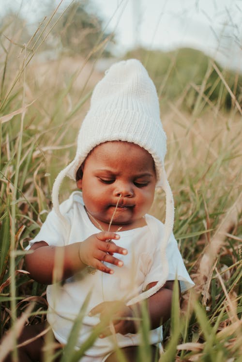 Free Cute Baby sitting on Grass Stock Photo