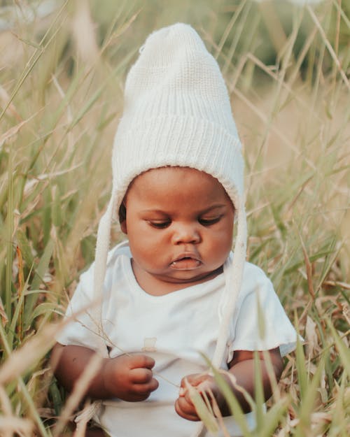 A Baby Wearing a Knitted Cap