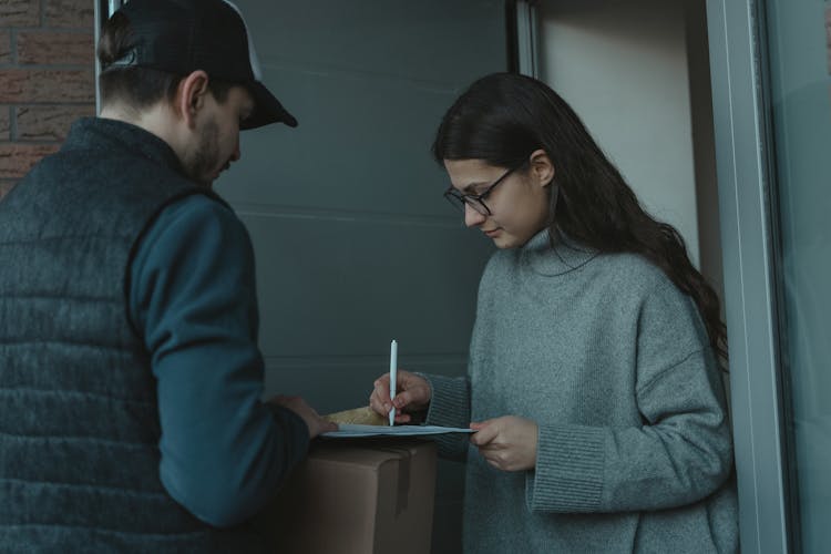 A Woman Receiving A Package 