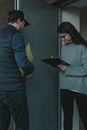 Man in Blue Sweater Holding Black Tablet Computer