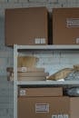 Brown Cardboard Boxes on a Steel Shelf
