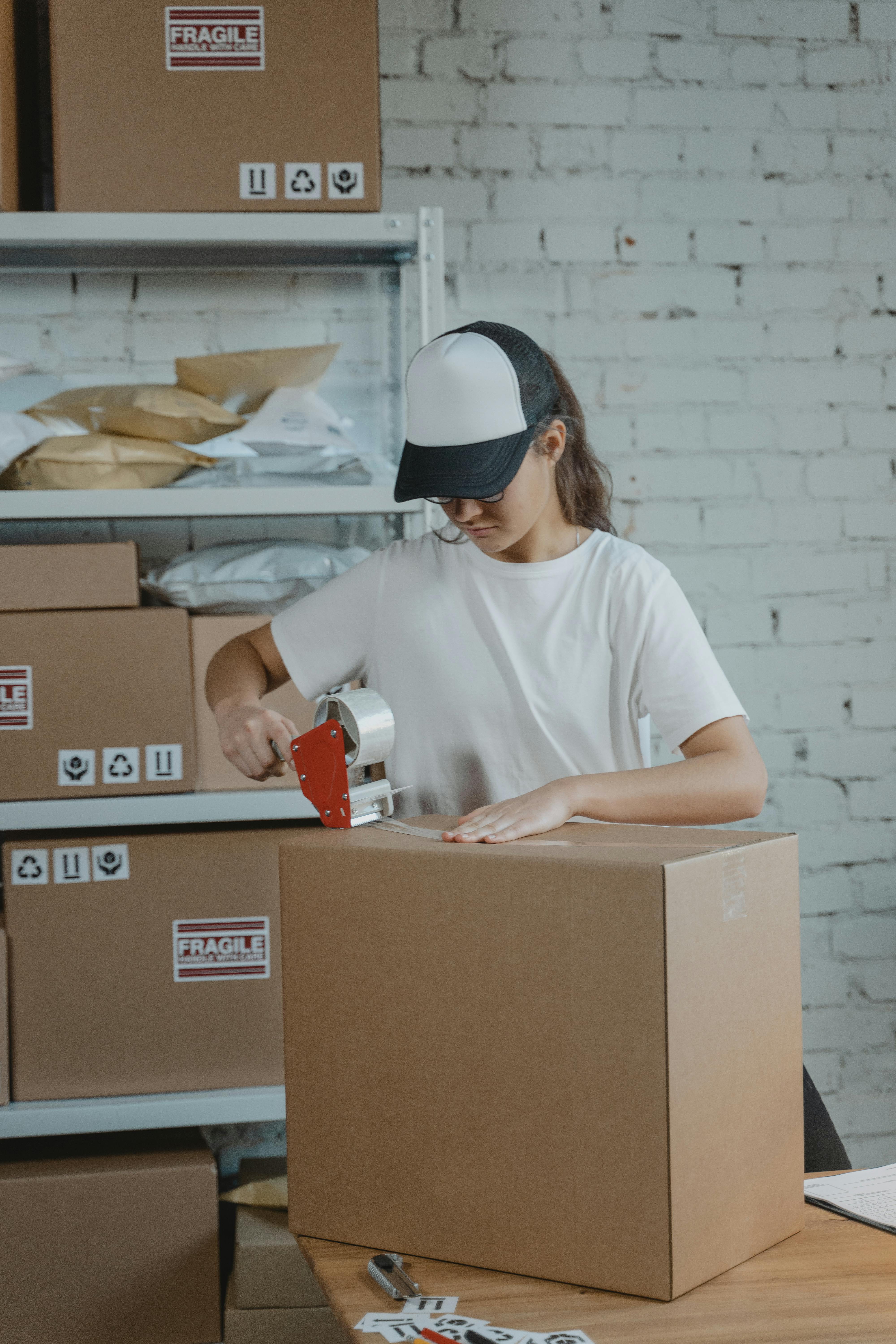 woman in white crew neck t shirt holding white and red ceramic mug