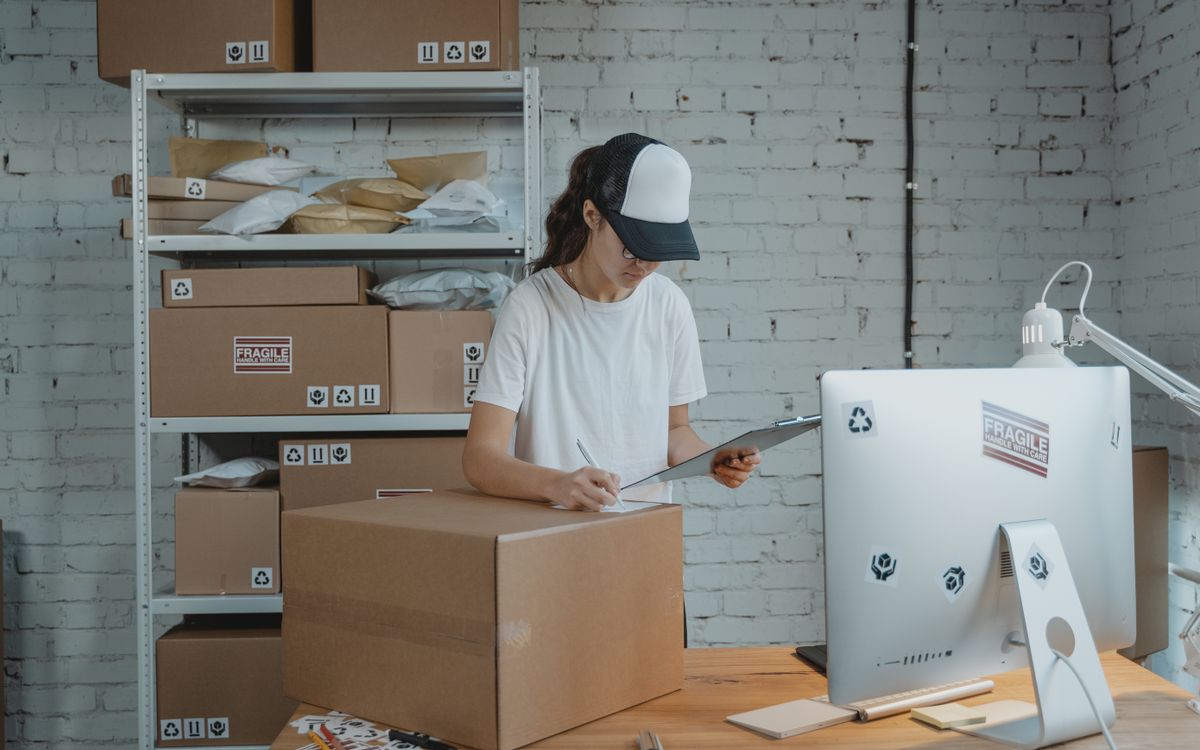 Woman managing shipping logistics for her small business, ensuring accurate inventory and order fulfillment.