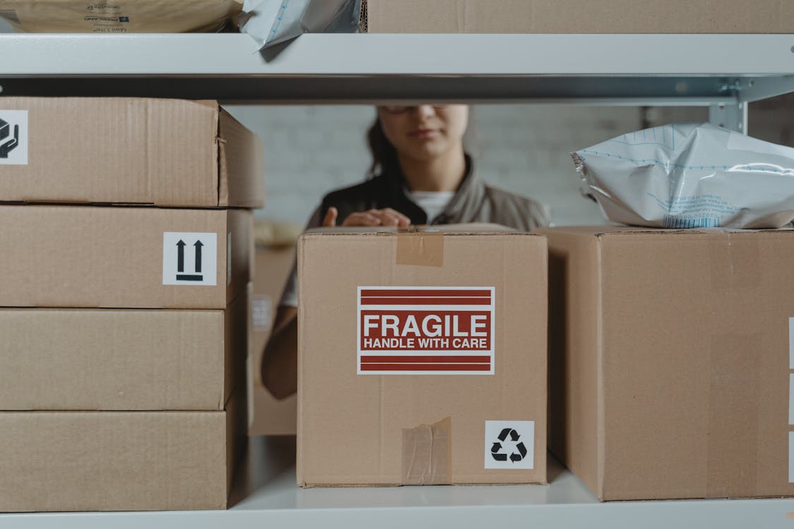 Free Brown Cardboard Box with Fragile Sticker  Stock Photo