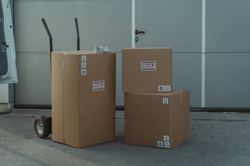 Brown Cardboard Boxes on a Concrete Ground 