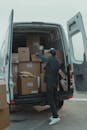 Delivery Man getting Parcels from a Van