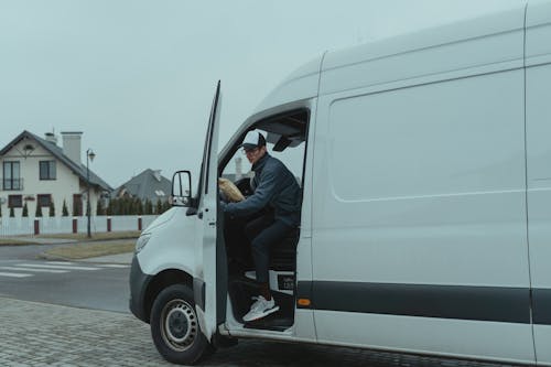 Delivery Man going out from a Van 