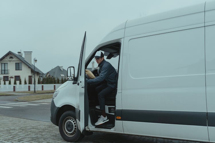 Delivery Man Going Out From A Van 