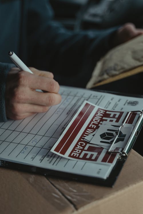 Person writing Down on a Document 