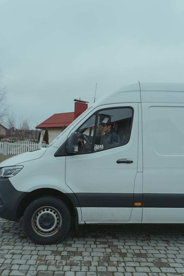 Man Driving A White Van 