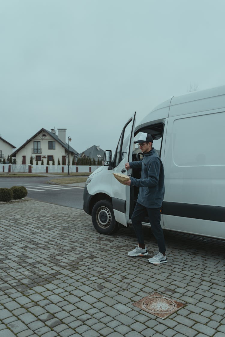 Delivery Man Going Out From A Van 