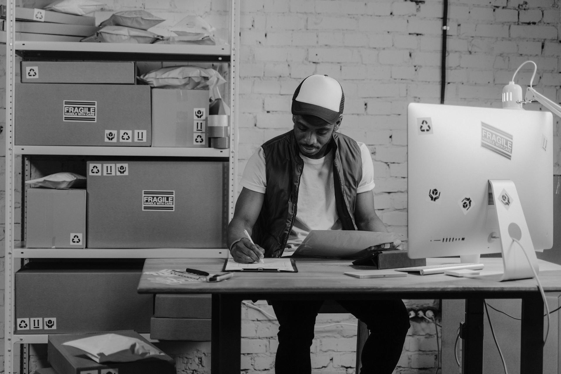 Monochrome Photo of a Business Man writing on a Paper