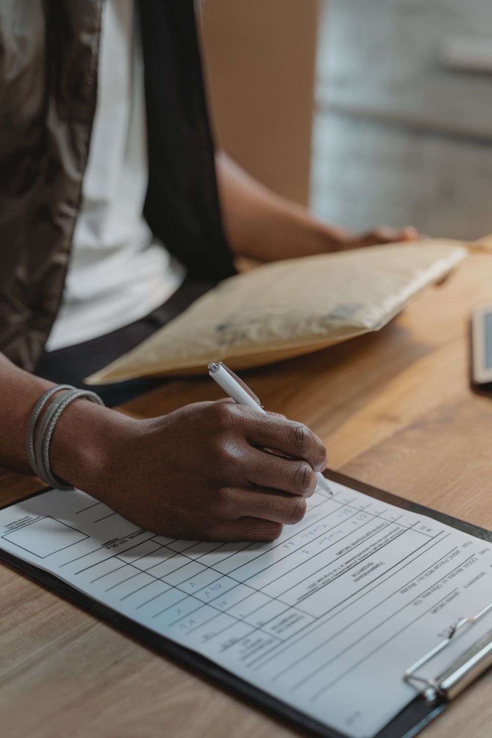 Person writing Down on a Document · Free Stock Photo