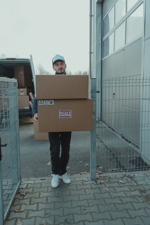 Delivery Man carrying Carton Boxes