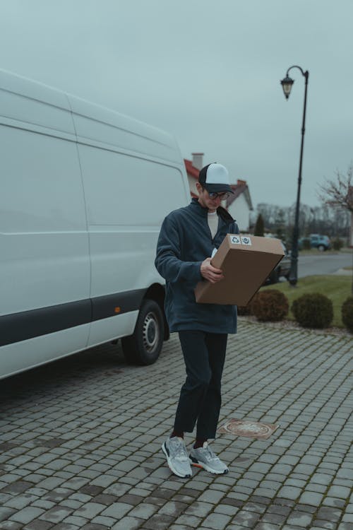 Free Delivery Man Carrying a Box Stock Photo
