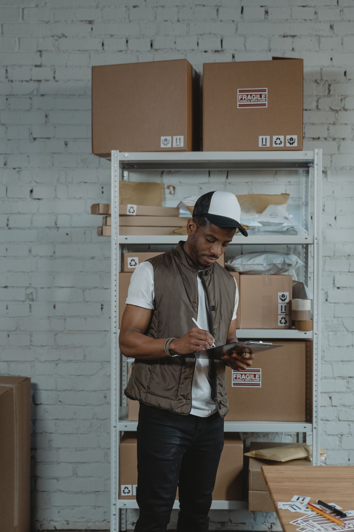 Courier checking shipment information in a warehouse